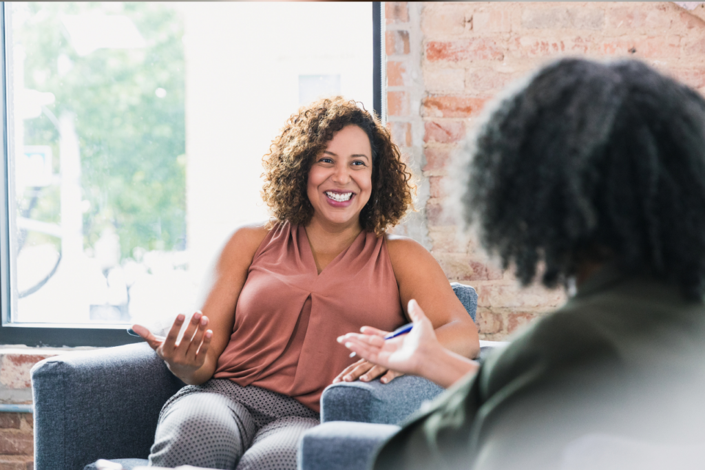 woman sitting with her therapist discussing What is OCD Caused By?