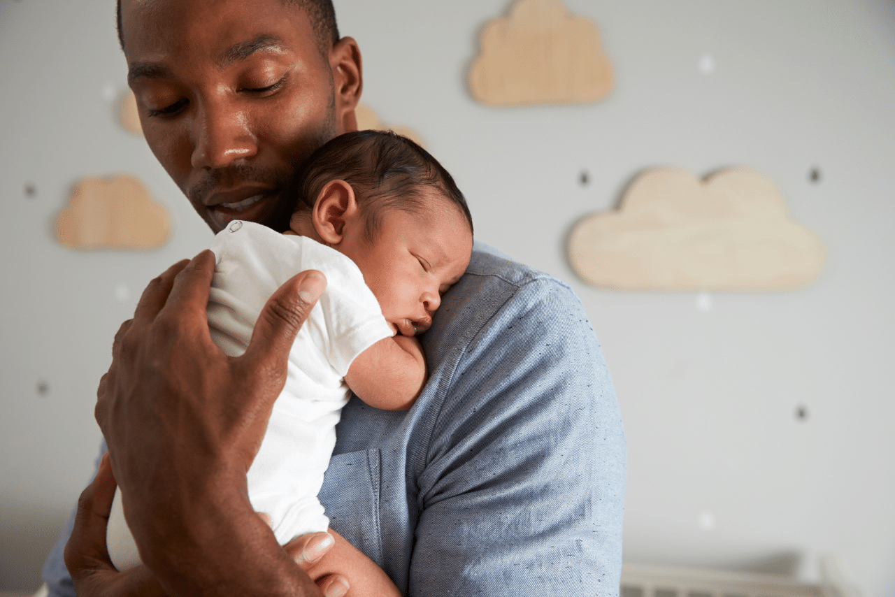 father holding his new born baby wondering can men get postpartum depression?