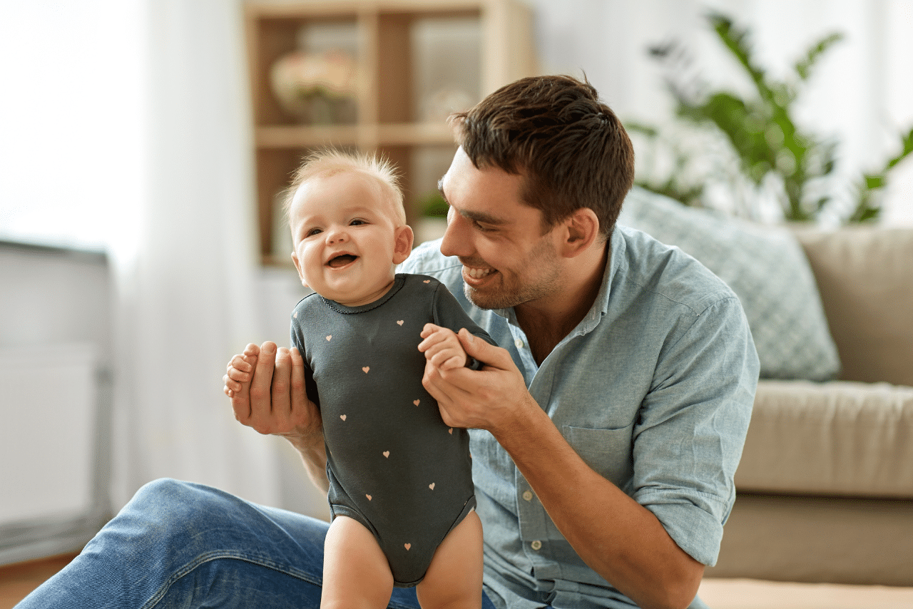 father holding his new born baby wondering can men get postpartum depression?