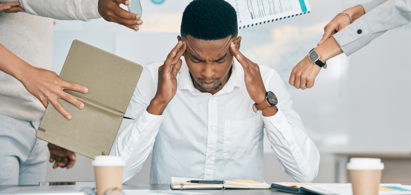 man sitting at his desk dealing with Anxiety Disorder in the Workplace||woman sitting in a chair struggling with Anxiety Disorder in the Workplace