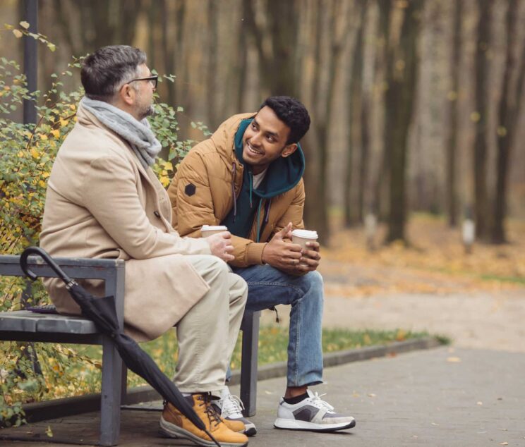 Friends,,A,Senior,And,A,Young,Man,Sit,In,The Five things to avoid saying when discussing someone's weightloss||friends discussing someone's recent weight loss