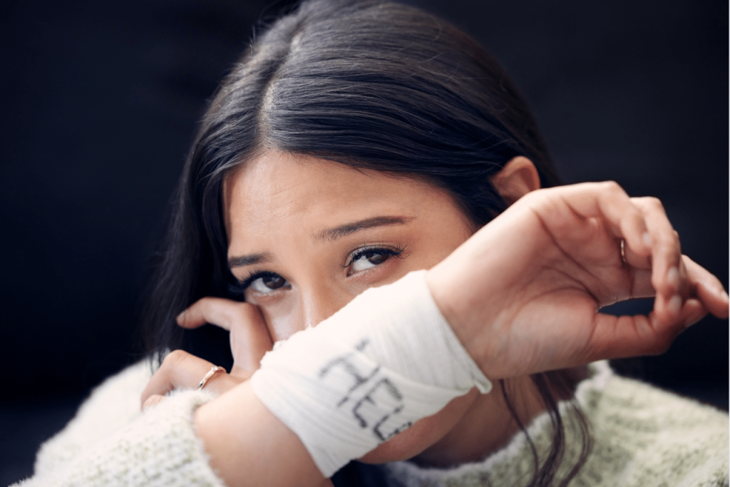 woman struggling with cutting wondering why do people cut themselves|patient speaking to his therapist about why do people cut themselves|woman sitting on the floor in the dark wondering why do people cut themselves