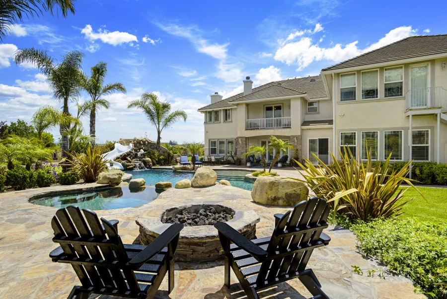 Pool terrace, firepit and garden seating beside The Meadowglade main house, part of optional supportive housing