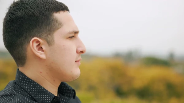 Side-profile portrait of Nate in the Meadowglade gardens