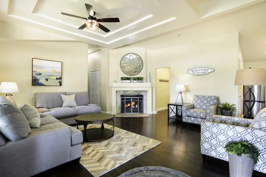 Residential cottage living room with fireplace, sofa and shared seating