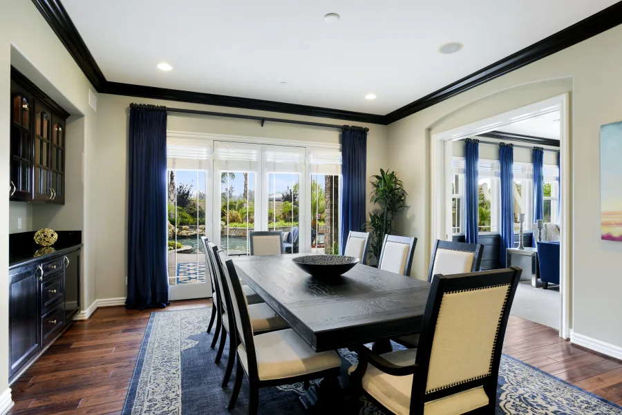 Dining table and garden-facing doors in The Meadowglade main house, part of optional supportive housing