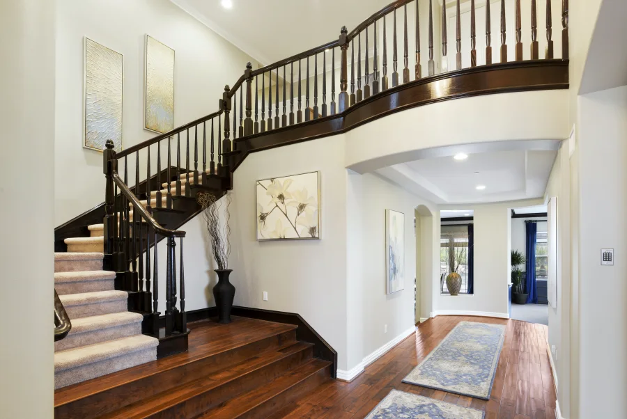 Curved wooden staircase and open entrance hall in The Meadowglade main house, part of optional supportive housing